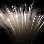 White and pink fireworks shooting up in the sky to celebrate New Years